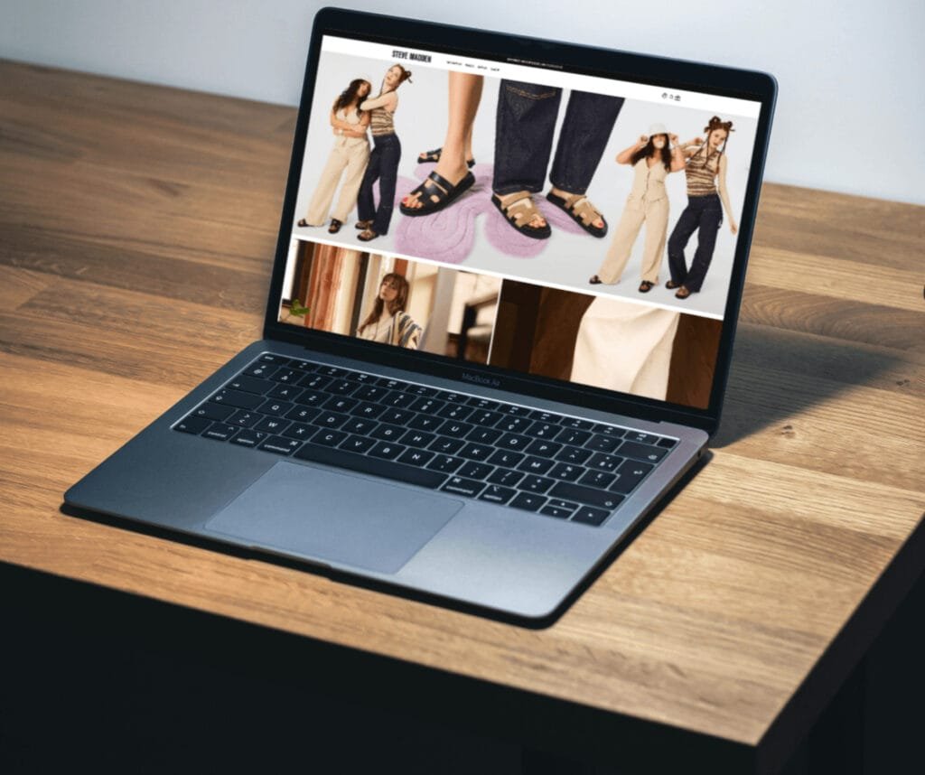 Laptop on textured rock surface displaying Bruno Anderson portfolio website with yellow-green background and iPhone mockup showing contact section